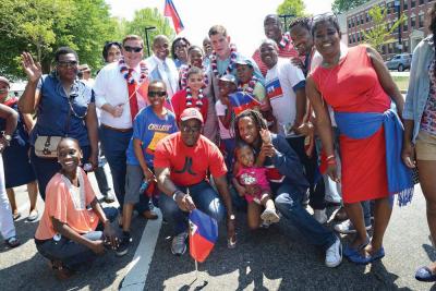 Sunday's Haitian Parade: Mayor Martin Walsh, center, led the Haitian Unity Parade on Sunday. The mayor met with a group of 250 Haitian community members in a forum held on Monday in Dorchester. 	Jeremiah Robinson/Mayor’s Office photo